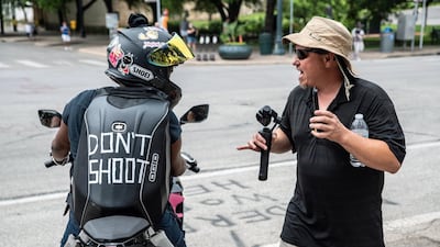 Black Lives Matter protesters confront people protesting against mandates to wear masks in Austin. Reuters