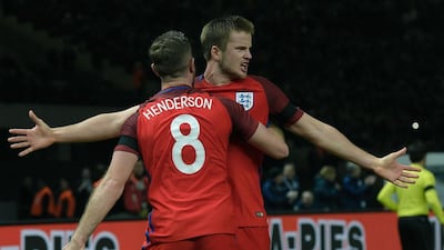 England’s midfielder Eric Dier celebrates scoring the winning goal with his team-mate England’s midfielder Jordan Henderson (front) during the friendly football match Germany v England at the Olympic Stadium in Berlin on March 26, 2016. England won the match 2-3. / AFP / TOBIAS SCHWARZ