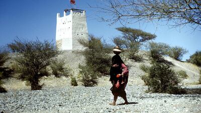 After childbirth, women were soon expected to resume their domestic tasks, like carrying water from the well, as shown here near Al Ain in 1953. Courtesy Ronald Codrai© TCA Abu Dhabi