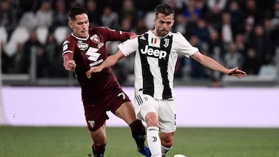 Torino midfielder Sasa Lukic, left, vies with Juventus midfielder Miralem Pjanic. AFP