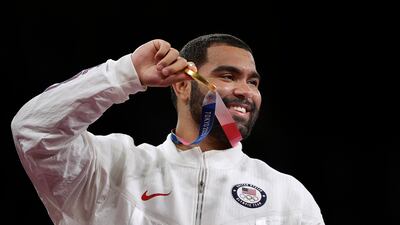 Gold medalist Gable Dan Steveson of the United States poses on the podium during the medal ceremony for men's freestyle 125 kg category at the wrestling events.