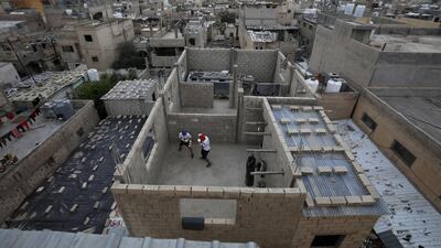 Jordanian brothers Hussein and Zeyad Ashish, boxers who qualified for next year's Olympics, engage in an online boxing training on the roof of their home during the curfew at Al-Baqaa Palestinian refugee camp, near Amman. Reuters