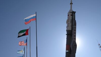 The Emirati, Russian and American flags fly as the Soyuz rocket stands in its vertical take-off position. James Langton / The National