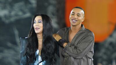 Singer Cher and Balmain creative director Olivier Rousteing take to the runway for the finale of the Balmain show. Getty Images