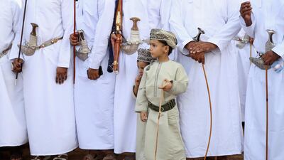 An Omani boy looks on as riders prepare to take part. Getty