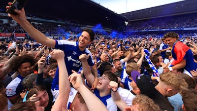 Lewis Travis of Ipswich Town celebrates promotion to the Premier League with supporters. Getty Images