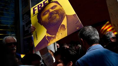 A protester holds up a placard with a portrait of jailed former Catalan vice-president Oriol Junqueras during the demonstration. AFP/Josep LAGO