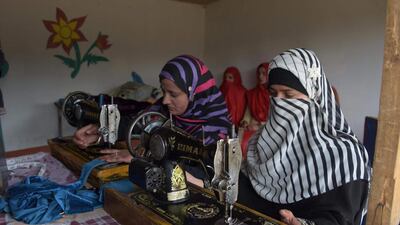 Pakistani Kashmiri girls stitch cloth during their class at the women's market on the outskirts of Rawalakot in Pakistani-administered Kashmir. Sajjad Qayyum/AFP