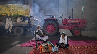 Farmers rest under a bridge near a police road block stopping them from marching to New Delhi to protest against the central government's recent agricultural reforms. AFP