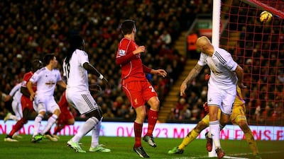 Jonjo Shelvey of Swansea City heads in an own goal during his side's Premier League loss on Monday to Liverpool. Clive Brunskill / Getty Images