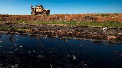 A US military armoured vehicle patrols in the town of Tal Tamr along the M4 highway in the northeastern Syrian Hasakeh province, near the border with Turkey. AFP