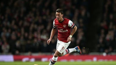 Arsenal's Mesut Ozil runs with the ball during an English Premier League match against Liverpool at the Emirates stadium. Dylan Martinez / Reuters