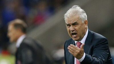 Romania's head coach Anghel Iordanescu gestures from the sidelines. Robert Ghement / EPA