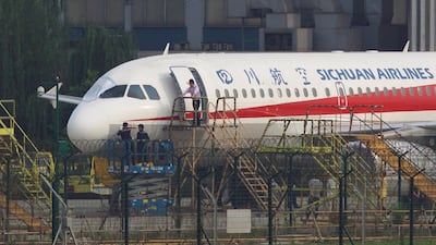 Workers inspect a Sichuan Airlines aircraft that made an emergency landing after a windshield on the cockpit broke off, at an airport in Chengdu, Sichuan province, China on May 14, 2018. Reuters