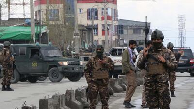 Afghan security personnel stand guard near the site of an attack to a Sikh temple in Kabul. AFP