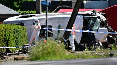 A police officer takes pictures at the site of an accident after a train crashed into a school bus, at a level crossing in Vierhuizen, Buggenhout, 20km north of Brussels. All photos: AFP