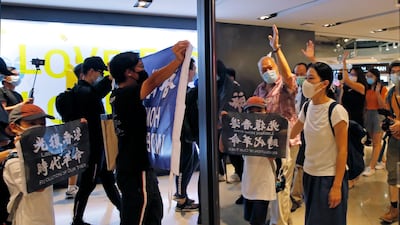 Protesters are reflected on a mirror as they march in a shopping mall during a protest in Hong Kong. Protesters in Hong Kong got its government to withdraw extradition legislation last year, but now they're getting a more dreaded national security law. And the message from Beijing is that protest is futile. AP Photo