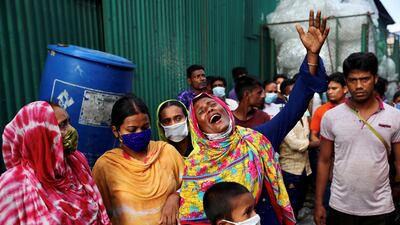 Unidentified relatives of the victims mourn at the site after a fire broke out at a factory named Hashem Foods Ltd. in Rupganj of Narayanganj district, on the outskirts of Dhaka, Bangladesh, July 9, 2021. REUTERS / Mohammad Ponir Hossain TPX IMAGES OF THE DAY