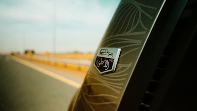 The model is adorned with a series of new badges