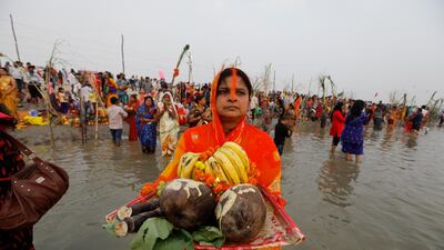 Hindu devotees perform rituals dedicated to the sun god on Chhat Puja festival in Prayagraj, India. Health officials have warned about the potential for the coronavirus to spread during the upcoming religious festival season. AP Photo