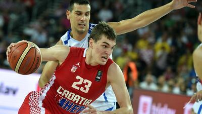 Croatia forward Mario Hezonja of the Orlando Magic dribbles by Greece's Nikos Zisis during a EuroBasket 2015 match on Sunday. Andrej Isakovic / AFP