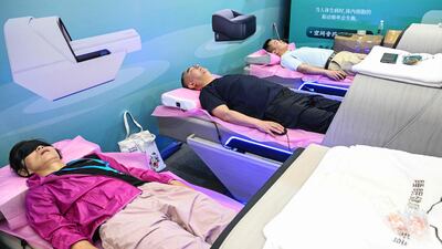 People test a sleep cabin during the International Exhibition of Senior Care, Rehabilitation Medicine and Healthcare in Shanghai. AFP