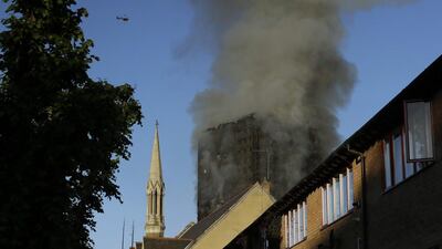 Much of the fire had been cleared as daylight broke through. Matt Dunham / AP Photo
