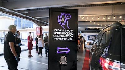 The drive-in cinema is making a comeback at Mall Of The Emirates, and a large screen has been assembled in the shopping centre's upper parking lot, on level 3, right underneath Ski Dubai's slope. Patrons take position, switch off their engines and settle in for the film. Reem Mohammed / The National