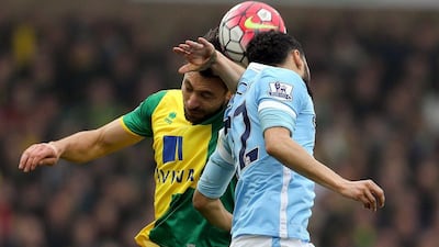 Norwich City’s Russell Martin, left, and Manchester City’s Gael Clichy battle for the ball battle for the ball during the Premier League match at Carrow Road, Norwich, England, Saturday March 12, 2016. (Chris Radburn/PA via AP)