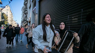 People leave the area after an explosion on Istanbul's popular pedestrian Istiklal Avenue Sunday. AP