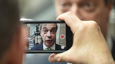 A man films Nigel Farage, the UKIP leader, as he speaks during an interview at an EU summit in Brussels. European Union leaders are holding a summit in Brussels to hammer out a deal designed to keep Britain in the 28-nation bloc. Geert Vanden Wijngaert / AP photo