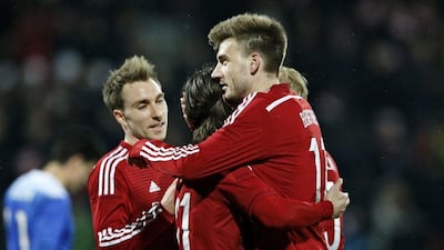 Denmark's Christian Eriksen, left, Lasse Vibe and Nicklas Bendtner, right, celebrate after a goal in their friendly win over the United States on Wednesday. Jens Dresling / AP / March 25, 2015