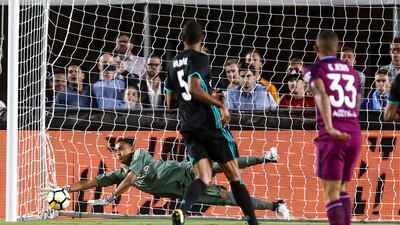 Real Madrid goalkeeper Keylor Navas, left, makes a save against Manchester City. Ringo Chiu / AFP