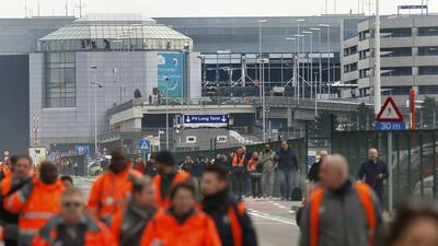 People leave the scene of explosions at Zaventem airport near Brussels, Belgium. Francois Lenoir / Reuters