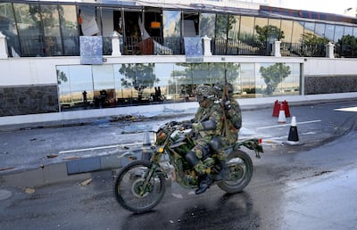 Sri Lankan Security personnel pass the damaged Kingsbury Hotel where a fatal blast ripped through the building on Sunday. EPA