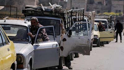 Drivers wait to fill their cars with fuel rations in Aleppo, Syria. Omar Sanadiki / Reuters