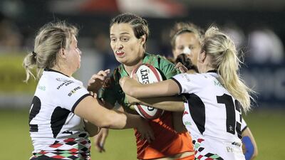 Holly Murphy of Knights Eagles takes on the Quins defence in the match between Dubai Knights Eagles and Abu Dhabi Harlequins in the Gulf Women's section at the Dubai Rugby Sevens. Chris Whiteoak / The National