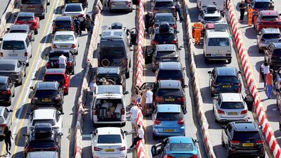 Passengers queue for ferries at the Port of Dover, during the hot weather, in Kent, England. PA via AP