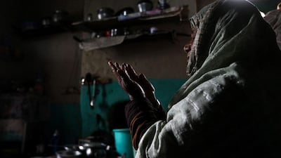 A patient prays in her room.