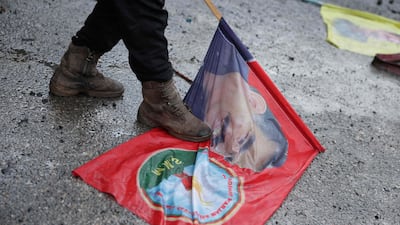 A foot steps on a flag with the image of jailed Kurdish leader Abdullah Ocalan. AFP
