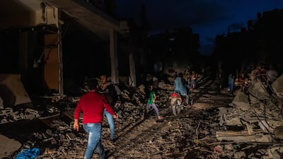 Palestinians walk around Beit Hanoun, northern Gaza, on May 22, 2021. Getty