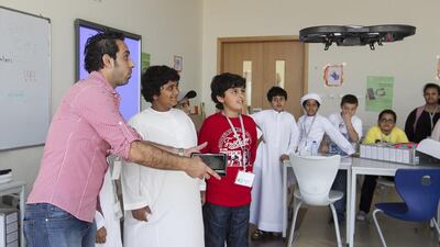 Teacher Ahmad Al Zaben shows pupils how to control and fly a drone during the two-week TechQuest programme at the Applied Technology High School in Mohammed bin Zayed City. Mona Al Marzooqi / The National