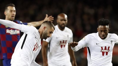 Messi (bottom) iis fouled by a Granada player. EPA