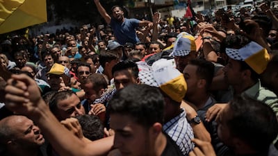 Mourners chant angry slogans as others carry the body of Palestinian activist Tamer Sultan, 38, during his funeral in town of Beit Lahiya, Northern Gaza Strip. AP