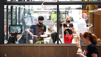 People sit inside a restaurant in Covent Garden, in London. Reuters