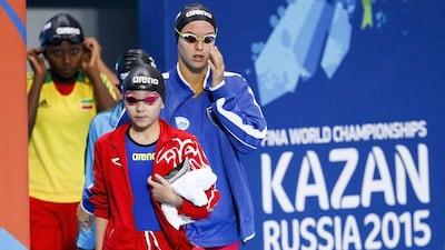 Alzain Tareq (front) of Bahrain walks in before competing in the women's 50m Butterfly heats during the Fina Swimming World Championships. Patrick B Kraemer / EPA
