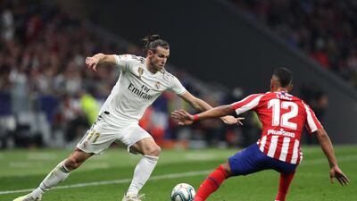 MADRID, SPAIN - SEPTEMBER 28: Gareth Bale of Real Madrid battles for the ball with Renan Lodi of Atletico Madrid during the Liga match between Club Atletico de Madrid and Real Madrid CF at Wanda Metropolitano on September 28, 2019 in Madrid, Spain. (Photo by Angel Martinez/Getty Images)