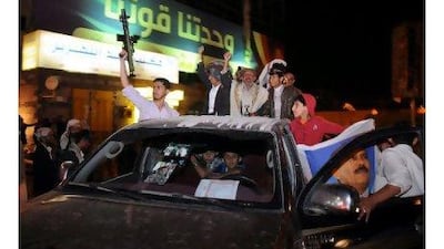 Yemeni men shout slogans celebrating the television appearance of their president, Ali Abdullah Saleh, in Sanaa on Thursday. Wadia Mohammed / EPA