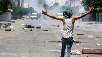 A protester from Tunisia's Tataouine region confronts security forces during clashes in the southern city on June 21, 2020. AFP