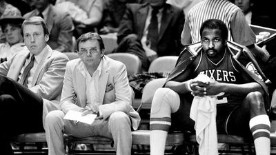 Philadelphia 76ers coach Billy Cunningham, left, trainer Al Domenico and center Moses Malone sit on the bench and watch the fourth period of their 111-73 blowout by the New York Knicks at New York's Madison Square Garden, Jan. 9, 1984. Ray Stubblebine / AP Photo